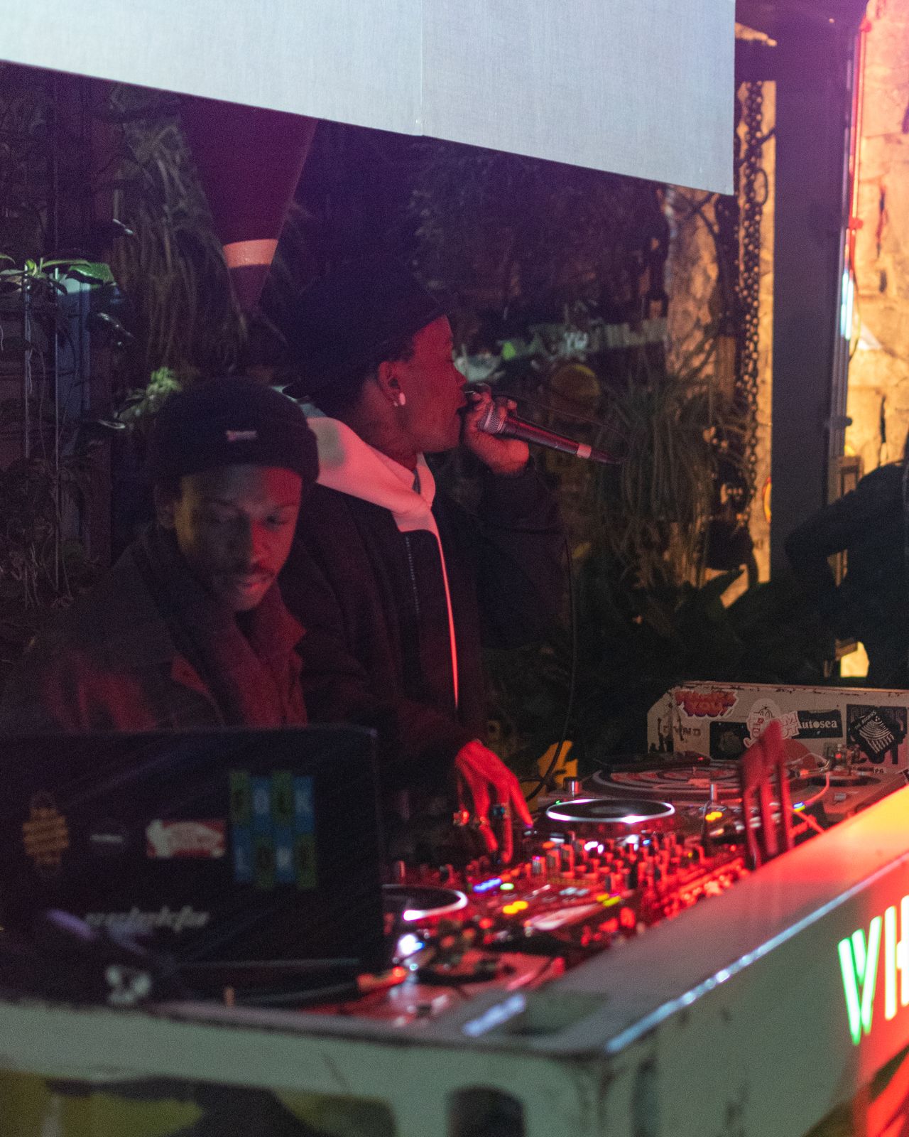 An MC on the mic beside the decks at an Ice Cream Sundays night